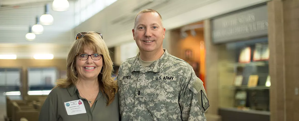 MBA student Lt. Matthew Ayers poses with Assist Dean of the School of Business Teresa Wilkerson.