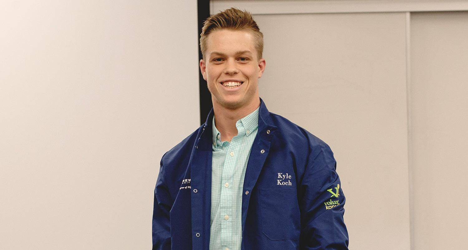 A Health Sciences student wears a ceremonial blue coat