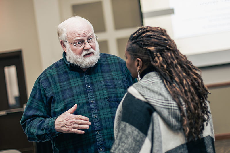 Two adults talking during an DBA dissertation